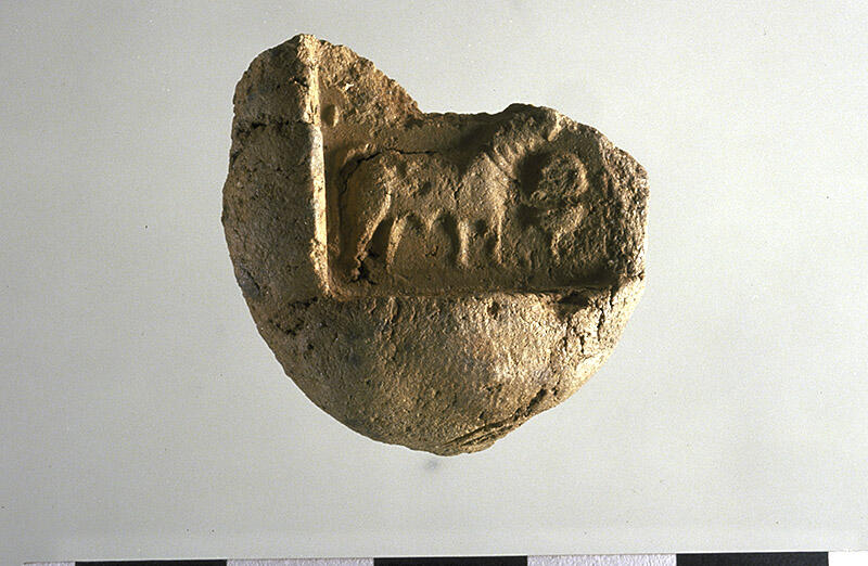 Low fired sealing in terra cotta of a unicorn seal from the Trench 54 area (H2000-4453/2174-192). This type of clay sealing was used to seal bundles of goods for transport.